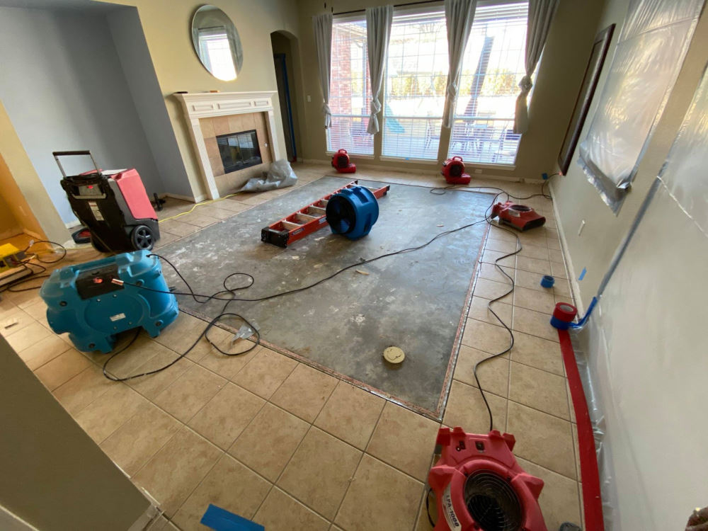 Water damage drying equipment set up in a Carrollton home — fans and dehumidifiers in action