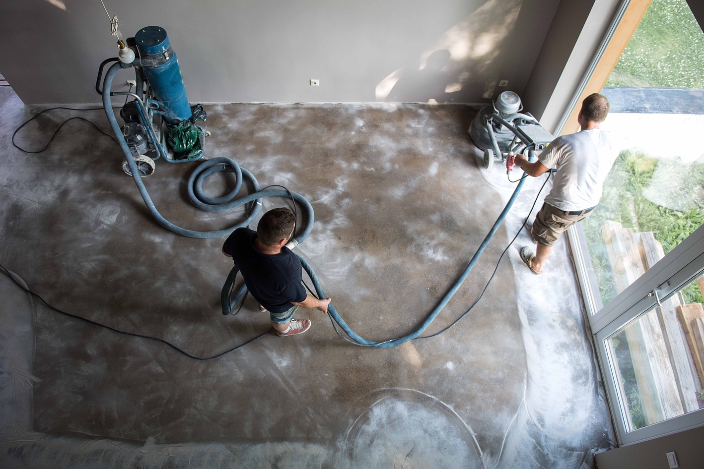 Professional water extraction team using industrial equipment to remove water from a damaged floor